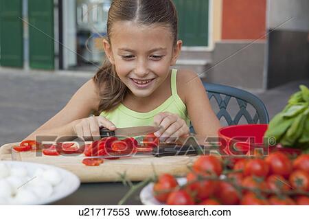 girl cutting tomatoes View Large Photo Image Stock Image - girl cutting tomatoes. Fotosearch