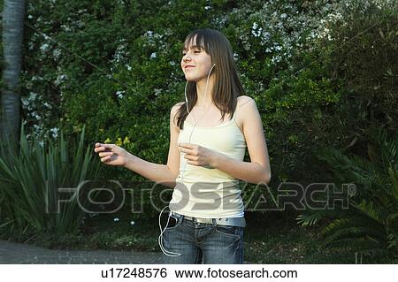 Girl dancing with earphones View Large Photo Image Stock Photograph - Girl dancing with earphones. Fotosearch