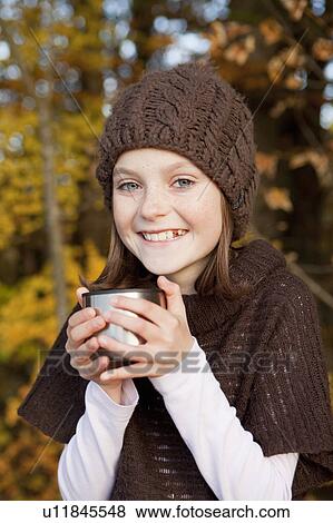 Girl drinking tea outside View Large Photo Image Stock Photo - Girl drinking tea outside. Fotosearch