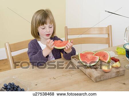 Stock Photo - girl eating watermelon. Fotosearch