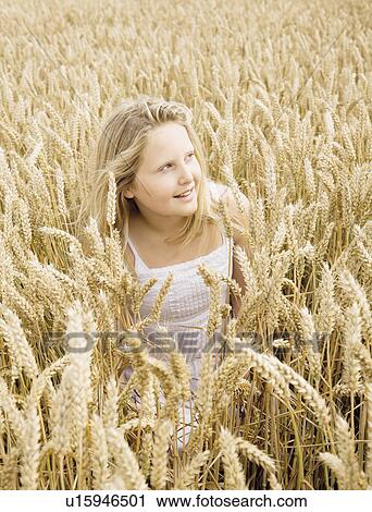 Girl hiding in wheat field View Large Photo Image Stock Image - Girl hiding in wheat field. Fotosearch
