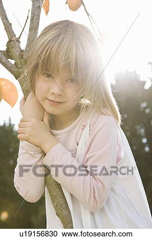 Girl hugging tree portrait View Large Photo Image Stock Image - Girl hugging tree portrait. Fotosearch