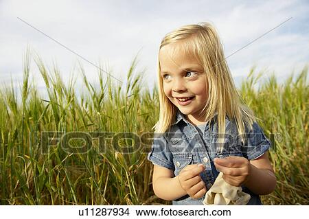 Picture - Girl in a wheat field. Fotosearch