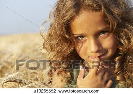 Stock Image - Girl in a wheat field. Fotosearch