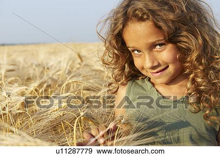 Stock Photo - Girl in a wheat field. Fotosearch