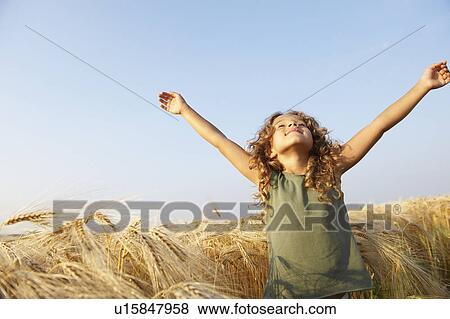 Girl in a wheat field View Large Photo Image Stock Photo - Girl in a wheat field. Fotosearch