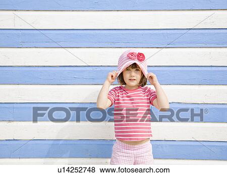 Girl in front of beach hut View Large Photo Image Stock Photo - Girl in front of beach hut. Fotosearch