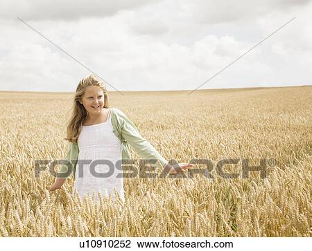 Stock Image - Girl in wheat Field. Fotosearch