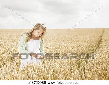 Stock Photograph - Girl in wheat Field. Fotosearch
