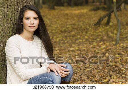 girl in woods against tree View Large Photo Image Stock Image - girl in woods against tree. Fotosearch