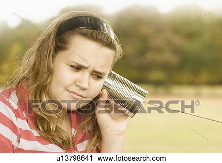 Girl Listening to Tin Can Phone View Large Photo Image Stock Image - Girl Listening to Tin Can Phone. Fotosearch