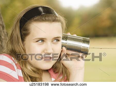 Girl Listening to Tin Can Phone View Large Photo Image Stock Photo - Girl Listening to Tin Can Phone. Fotosearch