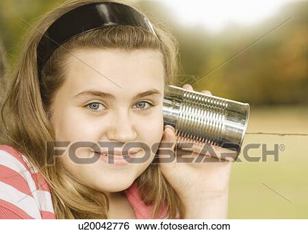 Girl Listening to Tin Can Phone View Large Photo Image Stock Photograph - Girl Listening to Tin Can Phone. Fotosearch