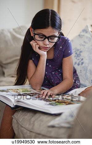 Stock Image - girl looking at picture book. Fotosearch