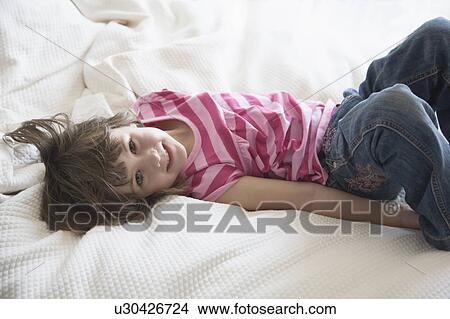 Girl on bed View Large Photo Image Picture - Girl on bed. Fotosearch