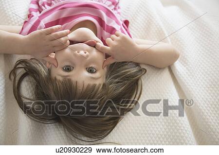 Girl on bed pulling face View Large Photo Image Stock Photo - Girl on bed pulling face. Fotosearch
