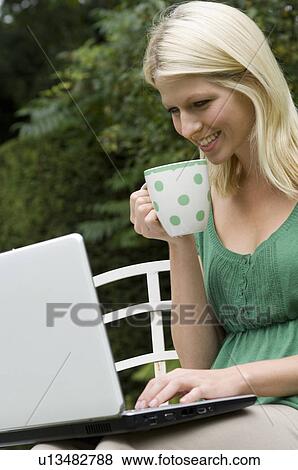 girl on computer with mug View Large Photo Image Stock Photo - girl on computer with mug. Fotosearch