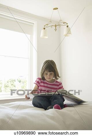 Girl reading on bed View Large Photo Image Stock Image - Girl reading on bed. Fotosearch