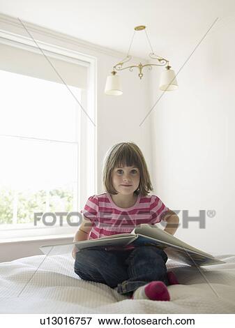 Girl reading on bed View Large Photo Image Stock Photo - Girl reading on bed. Fotosearch