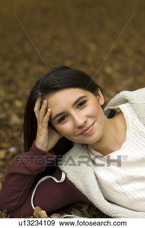 girl resting on leaves View Large Photo Image Stock Photo - girl resting on leaves. Fotosearch