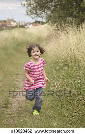 Girl running down path View Large Photo Image Stock Image - Girl running down path. Fotosearch