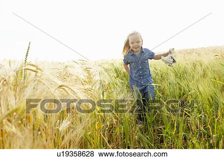 Stock Photo - Girl running in a wheat field. Fotosearch