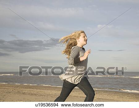 Girl running on beach View Large Photo Image Picture - Girl running on beach. Fotosearch