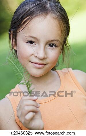 girl showing plant to viewer View Large Photo Image Stock Photography - girl showing plant to viewer. Fotosearch