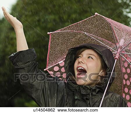 Girl singling holding an umbrella View Large Photo Image Stock Image - Girl singling holding an umbrella. Fotosearch