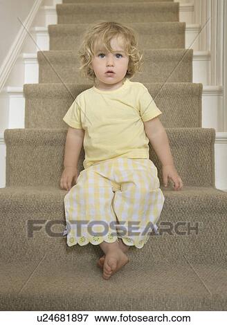 Stock Photo - Girl sitting on stairs. Fotosearch