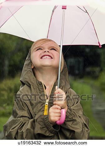 Girl smiling holding umbrella View Large Photo Image Stock Image - Girl smiling holding umbrella. Fotosearch