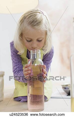 girl sniffing jar of liquid View Large Photo Image Stock Photograph - girl sniffing jar of liquid. Fotosearch
