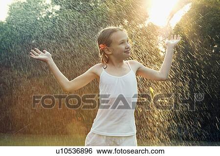 Girl standing in rain View Large Photo Image Stock Photograph - Girl standing in rain. Fotosearch