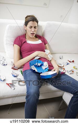 Stock Photo - girl suffering from too much chocolate. Fotosearch
