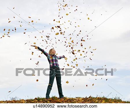 girl throwing autumn leaves into the air View Large Photo Image Stock Image - girl throwing autumn leaves into the air. Fotosearch