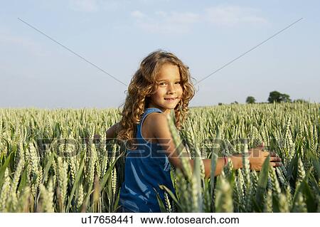 Girl walking in a wheat field View Large Photo Image Stock Image - Girl walking in a wheat field. Fotosearch