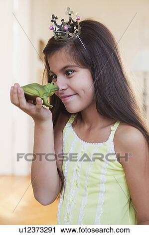 girl wearing crown playing with toy frog View Large Photo Image Stock Image - girl wearing crown playing with toy frog. Fotosearch