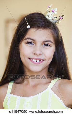 Stock Image - girl wearing crown smiling. Fotosearch