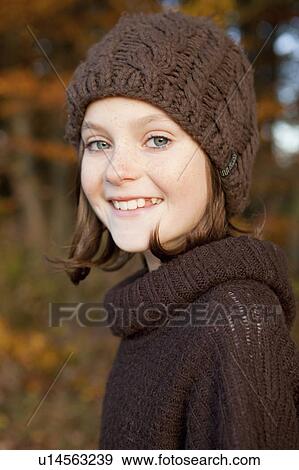 Stock Photo - Girl with brown beanie and pullover. Fotosearch