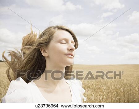 Girl with eyes closed in wheat field View Large Photo Image Picture - Girl with eyes closed in wheat field. Fotosearch