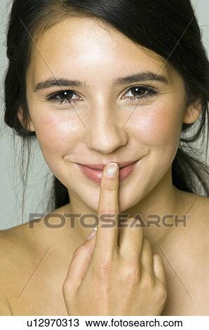girl with finger to lips View Large Photo Image Stock Image - girl with finger to lips. Fotosearch