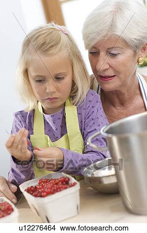 girl with grandmother cooking jam View Large Photo Image Picture - girl with grandmother cooking jam. Fotosearch