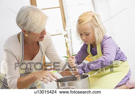 girl with grandmother cooking jam View Large Photo Image Picture - girl with grandmother cooking jam. Fotosearch