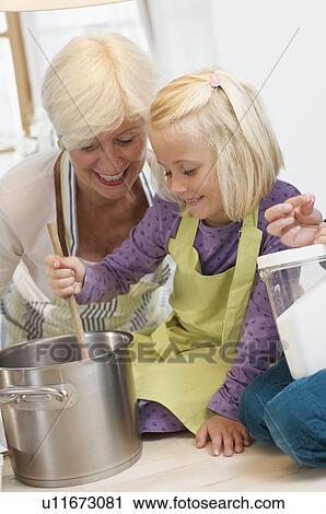 girl with grandmother cooking jam View Large Photo Image Stock Image - girl with grandmother cooking jam. Fotosearch