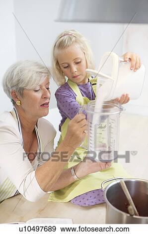 girl with grandmother cooking jam View Large Photo Image Stock Photo - girl with grandmother cooking jam. Fotosearch