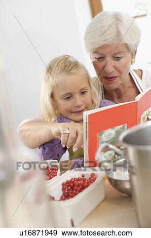 girl with grandmother cooking jam View Large Photo Image Stock Photo - girl with grandmother cooking jam. Fotosearch