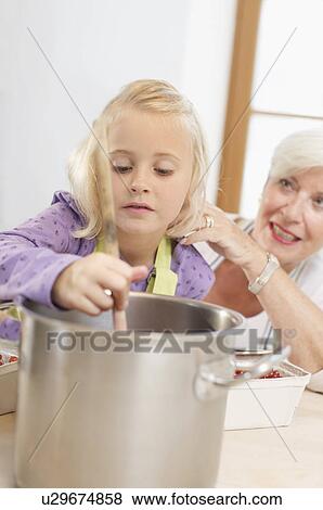 girl with grandmother cooking jam View Large Photo Image Stock Photo - girl with grandmother cooking jam. Fotosearch