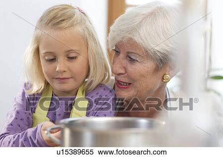 girl with grandmother cooking jam View Large Photo Image Stock Photography - girl with grandmother cooking jam. Fotosearch