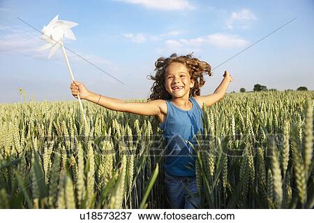 Girl with in a pinwheel in a field View Large Photo Image Stock Photo - Girl with in a pinwheel in a field. Fotosearch