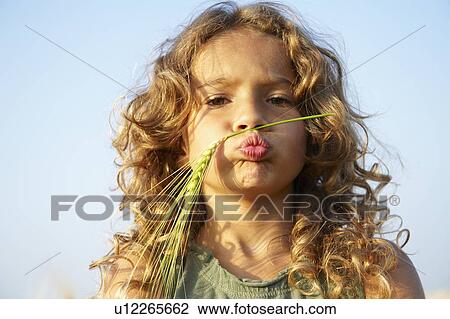 Girl with wheat on her face View Large Photo Image Stock Image - Girl with wheat on her face. Fotosearch